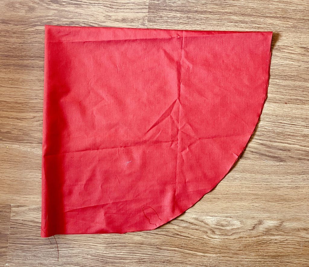 Doblar la tela en cuatro y cortar de forma circular del largo que queramos la capa.