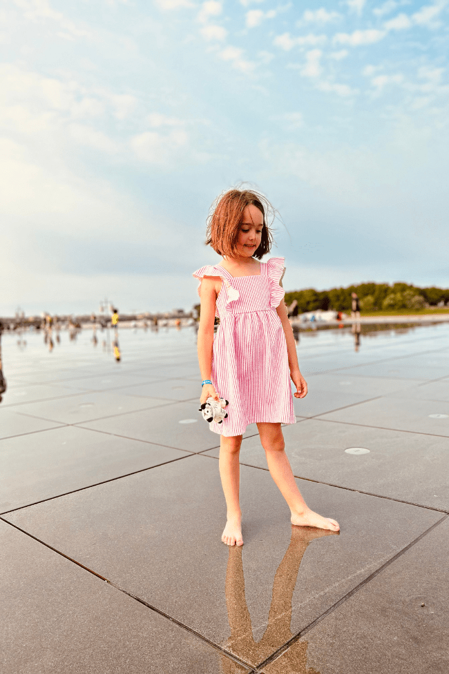 niña de seis años en el espejo de agua . que ver en burdeos